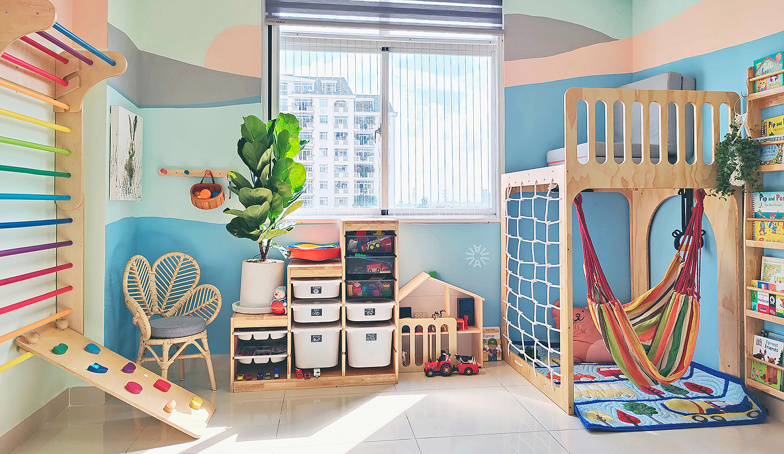 Colourful kids' playroom with a rainbow climbing ladder, loft bed and hammock