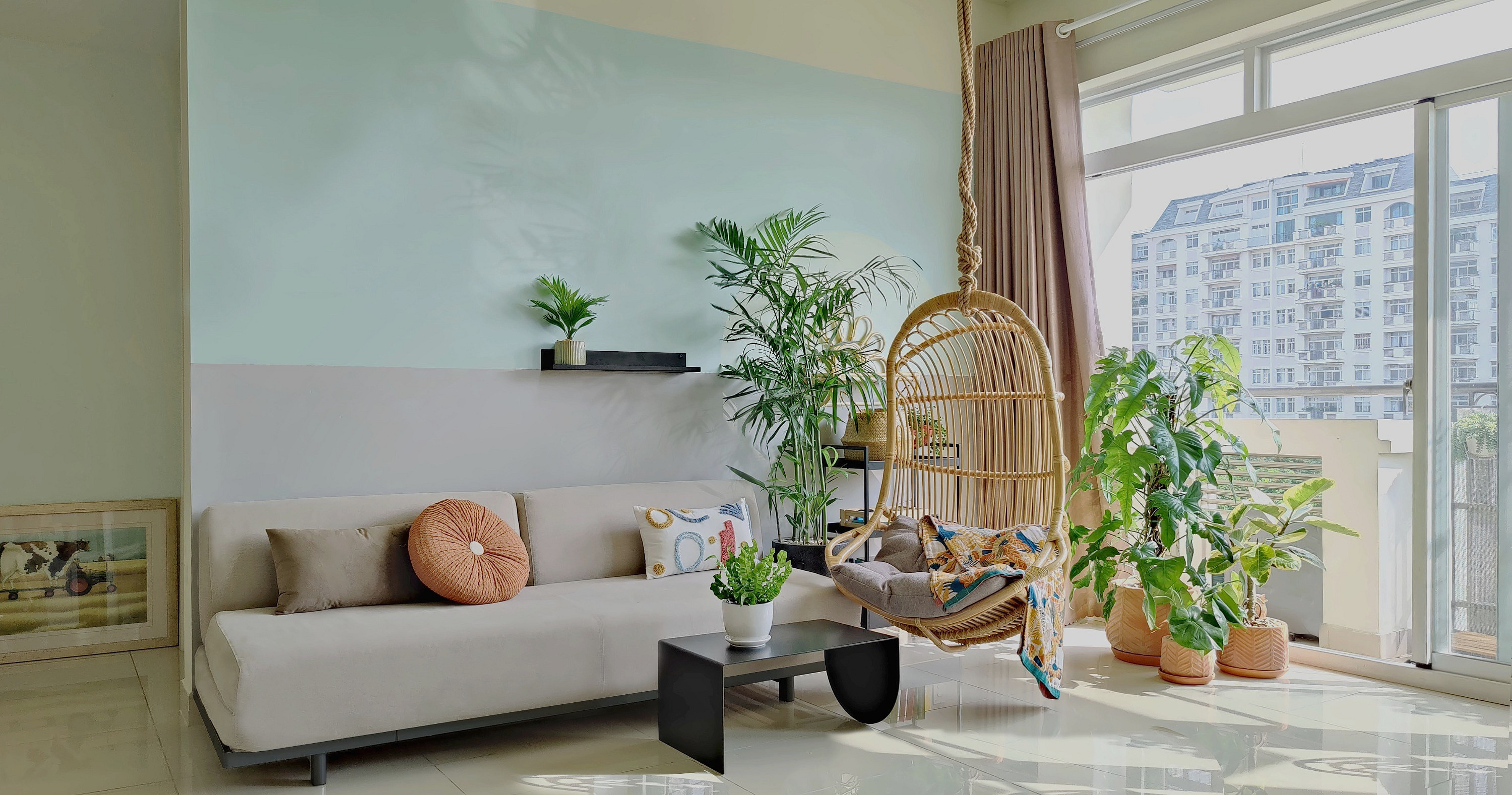 Bright living room with a rattan hanging chair and plants